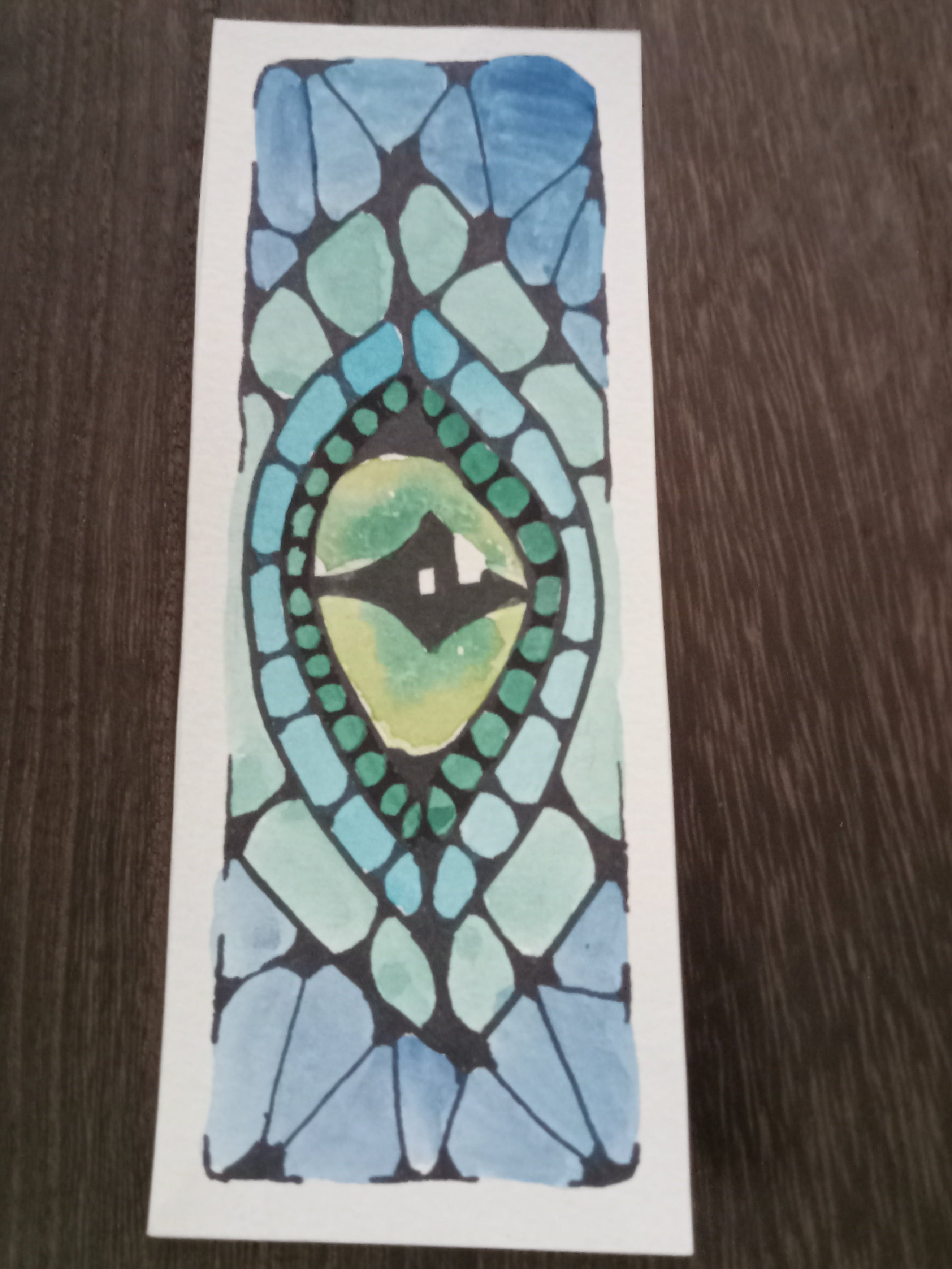 Sticker with a mosaic design of an eye on a wooden surface