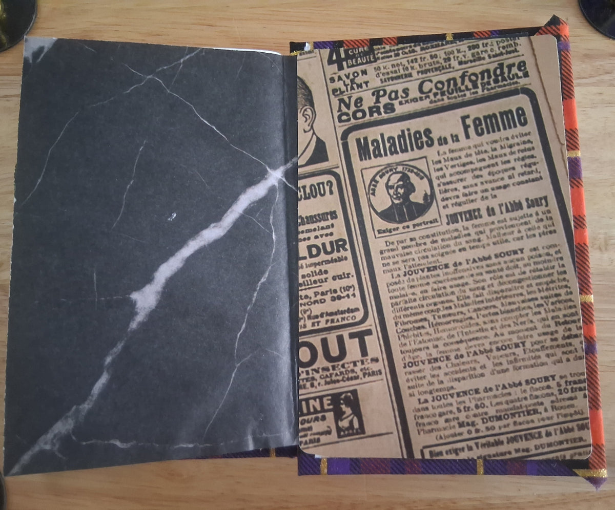 Decorative interior with dark marble-style and vintage newspaper-style panels
