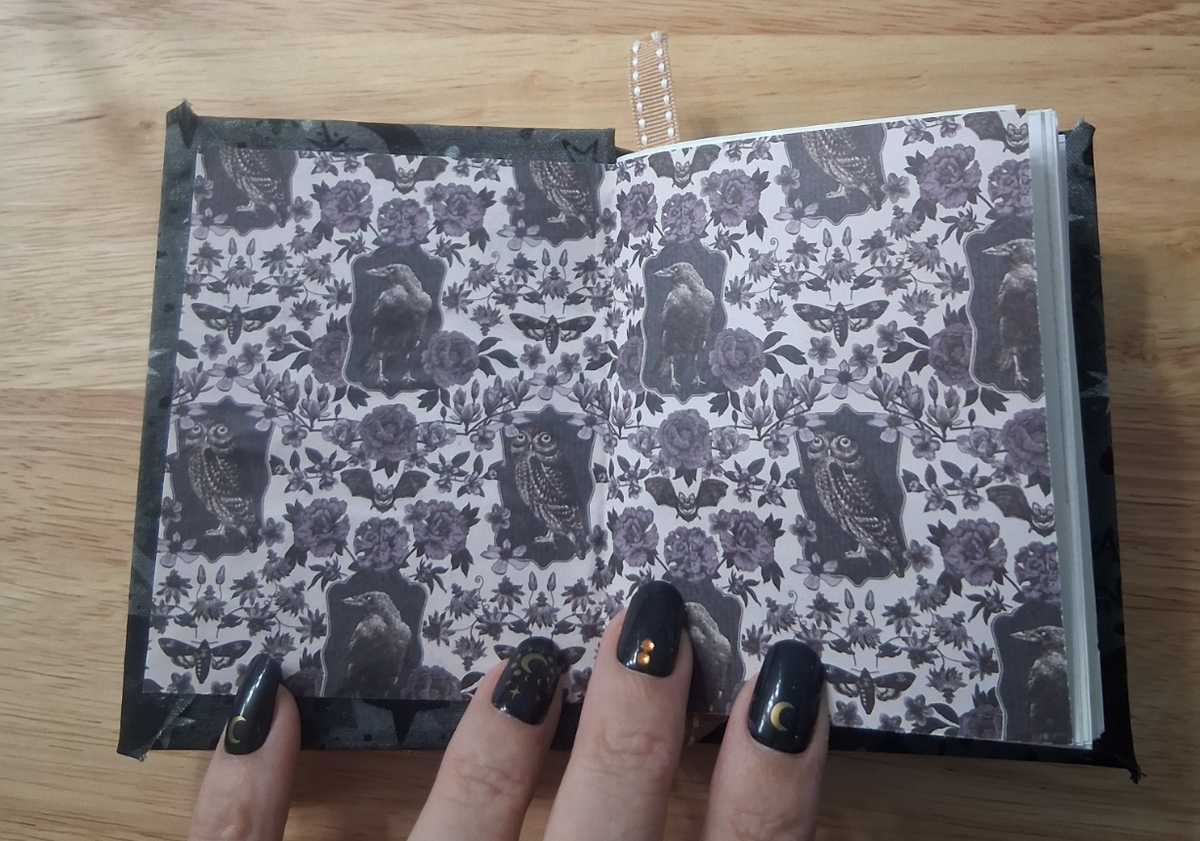 Decorative journal interior featuring birds, owls, moths, and flowers