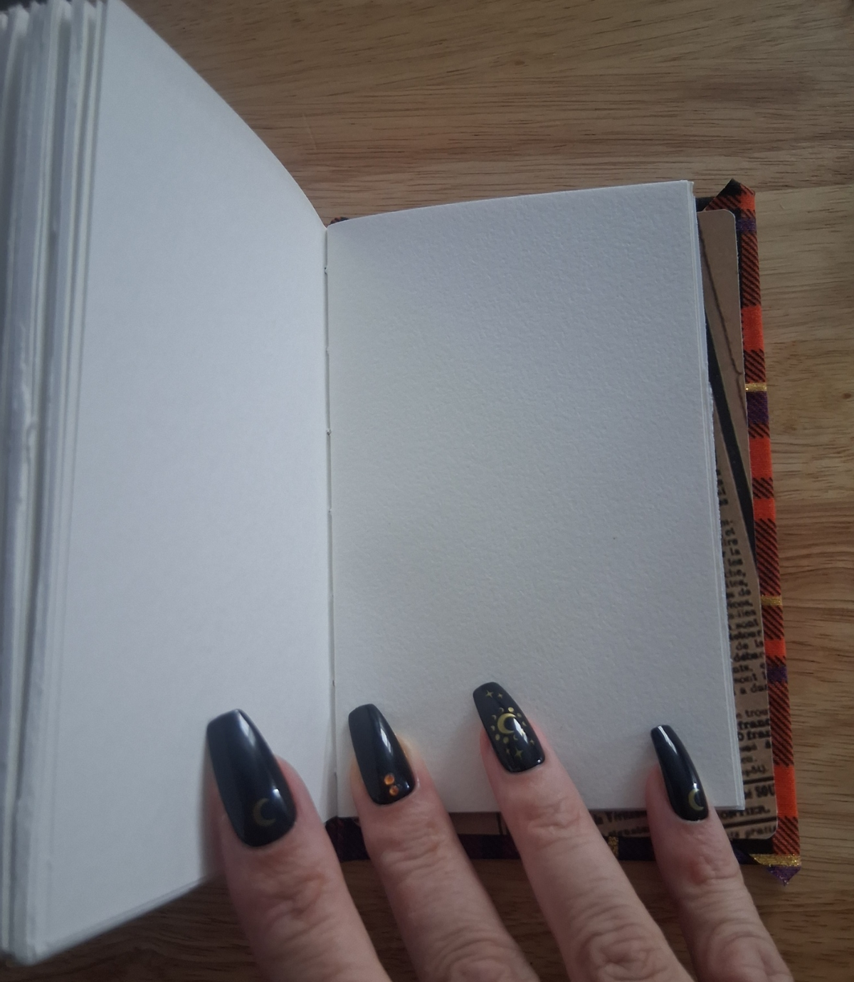 Blank Canson mixed-media pages inside hand-stitched journal